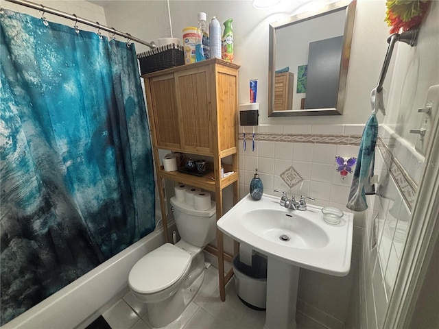 717 Whiteway Dr, Brooksville, FL 34601 - bathroom with tile walls, toilet, shower / bathtub combination with curtain, tile patterned floors, and wainscoting