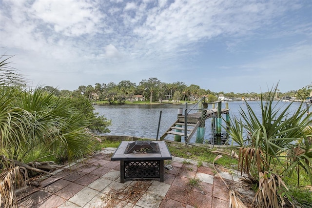7424 Grand Blvd, New Port Richey, FL 34652 - view of patio / terrace featuring an outdoor fire pit, a water view, a boat dock, and boat lift