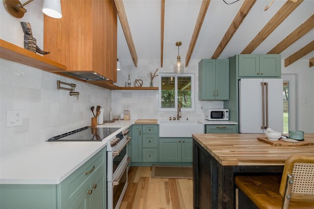 7424 Grand Blvd, New Port Richey, FL 34652 - kitchen featuring white appliances, a sink, beam ceiling, green cabinets, and light wood-type flooring
