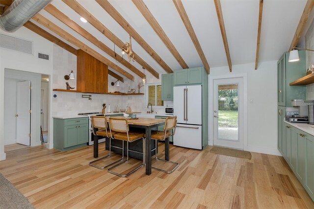 7424 Grand Blvd, New Port Richey, FL 34652 - kitchen with white refrigerator, green cabinetry, open shelves, and light countertops