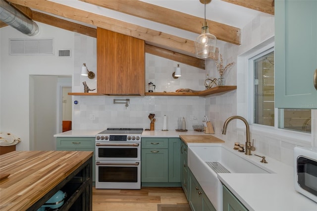 7424 Grand Blvd, New Port Richey, FL 34652 - kitchen with green cabinetry, double oven range, open shelves, decorative backsplash, and light wood finished floors