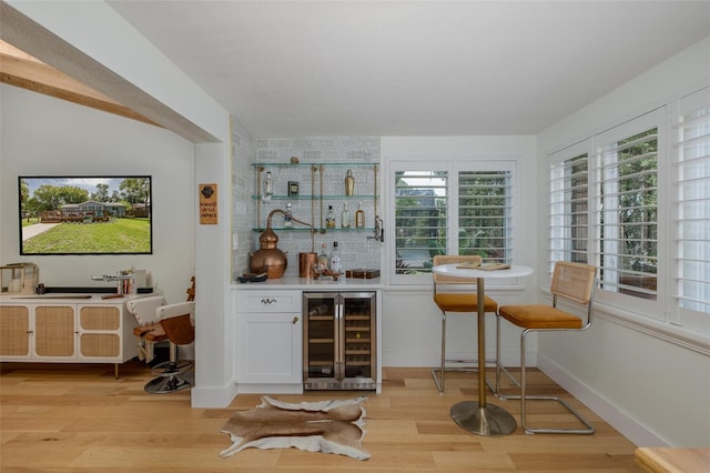 7424 Grand Blvd, New Port Richey, FL 34652 - indoor bar with beverage cooler, light wood-style floors, and healthy amount of natural light