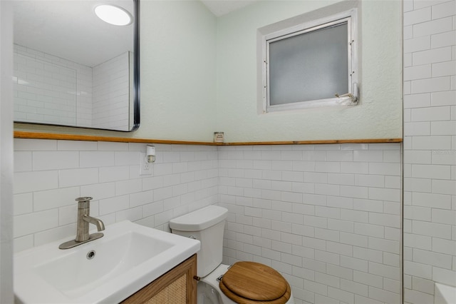 7424 Grand Blvd, New Port Richey, FL 34652 - bathroom featuring tile walls, toilet, and vanity