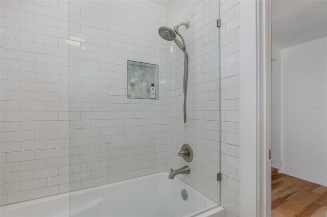 7424 Grand Blvd, New Port Richey, FL 34652 - full bath featuring shower / tub combination, wood finished floors, and baseboards