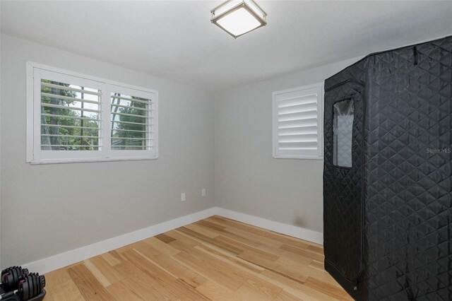 7424 Grand Blvd, New Port Richey, FL 34652 - unfurnished room featuring wood finished floors and baseboards
