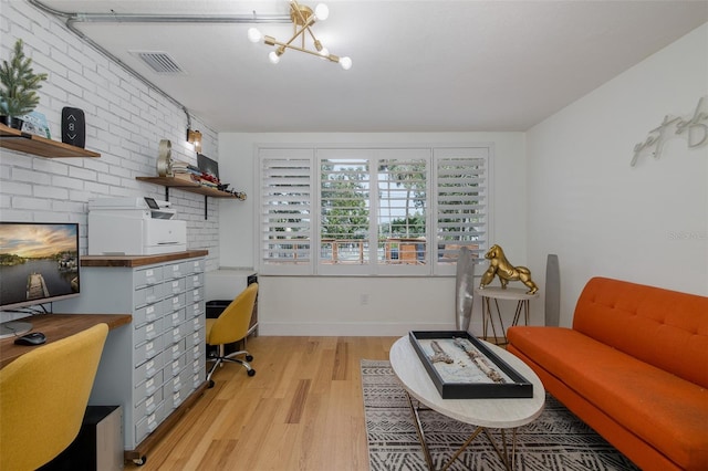 7424 Grand Blvd, New Port Richey, FL 34652 - home office with light wood-style flooring and a chandelier