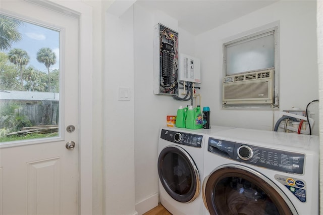 7424 Grand Blvd, New Port Richey, FL 34652 - laundry room featuring washing machine and dryer, healthy amount of natural light, water heater, and baseboards