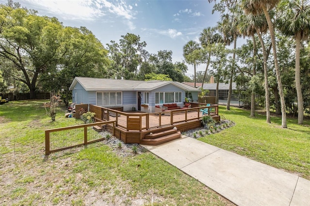 7424 Grand Blvd, New Port Richey, FL 34652 - single story home with a wooden deck, an outdoor hangout area, a front yard, and view of wooded area
