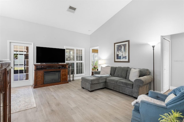 7923 Woburn St, New Port Richey, FL 34653 - living room featuring light wood-type flooring and high vaulted ceiling