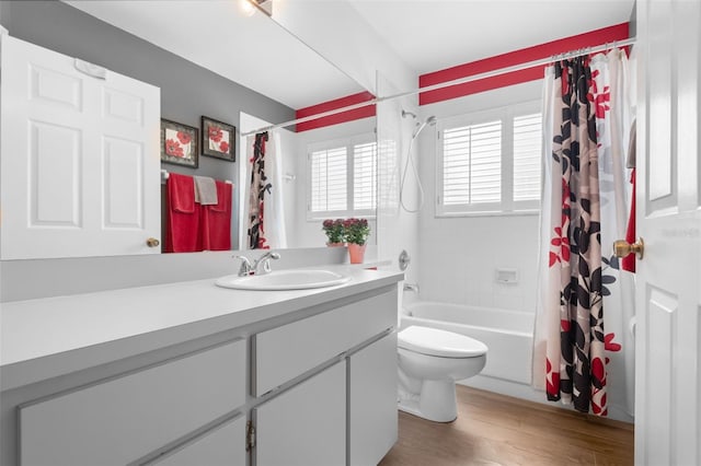 7923 Woburn St, New Port Richey, FL 34653 - full bath with vanity, shower / bath combo with shower curtain, toilet, and wood finished floors