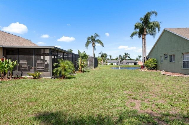 7923 Woburn St, New Port Richey, FL 34653 - view of grassy yard with a water view and a sunroom