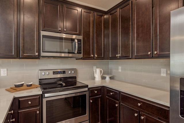 5520 White Marlin Ct, New Port Richey, FL 34652 - kitchen featuring stainless steel appliances, backsplash, light countertops, and dark brown cabinets