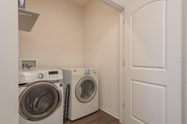 5520 White Marlin Ct, New Port Richey, FL 34652 - washroom with independent washer and dryer, dark wood-style floors, and baseboards