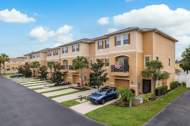 5520 White Marlin Ct, New Port Richey, FL 34652 - multi unit property featuring stucco siding, driveway, a residential view, a garage, and a front yard