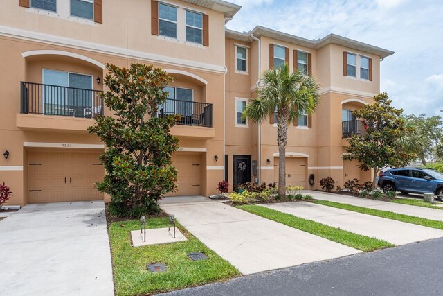 5520 White Marlin Ct, New Port Richey, FL 34652 - multi unit property with stucco siding, an attached garage, and driveway