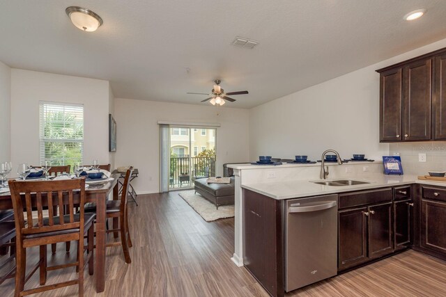 5520 White Marlin Ct, New Port Richey, FL 34652 - kitchen featuring dishwasher, a sink, light wood finished floors, open floor plan, and light countertops