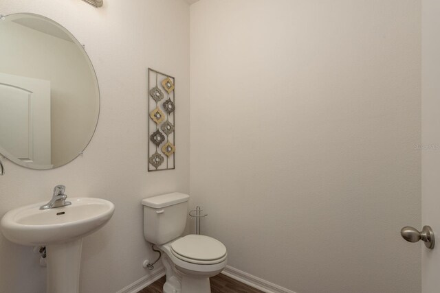 5520 White Marlin Ct, New Port Richey, FL 34652 - bathroom featuring baseboards, wood finished floors, and toilet