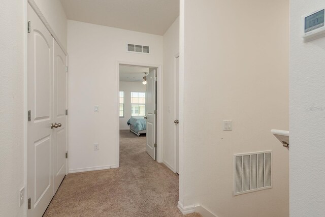 5520 White Marlin Ct, New Port Richey, FL 34652 - hallway with light colored carpet and baseboards