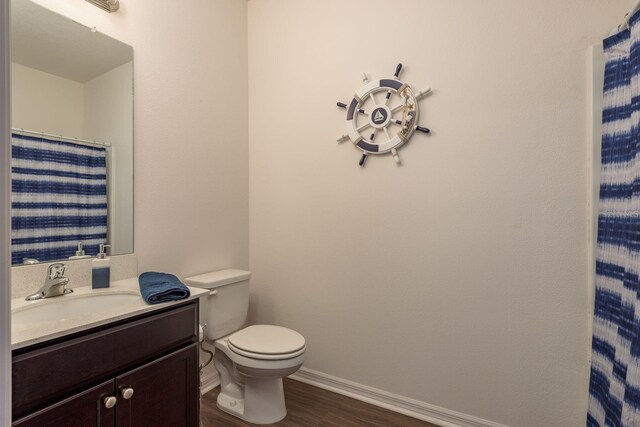 5520 White Marlin Ct, New Port Richey, FL 34652 - full bath with toilet, vanity, wood finished floors, and baseboards