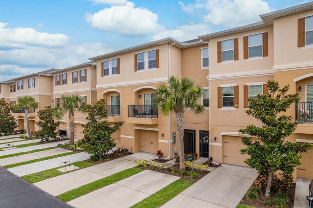 5520 White Marlin Ct, New Port Richey, FL 34652 - townhome / multi-family property featuring an attached garage, stucco siding, and driveway
