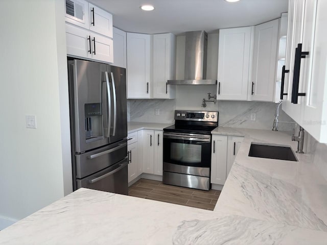4104 Pine Dale Ct, Hernando Beach, FL 34607 - kitchen with stainless steel appliances, wall chimney exhaust hood, a sink, light stone counters, and recessed lighting
