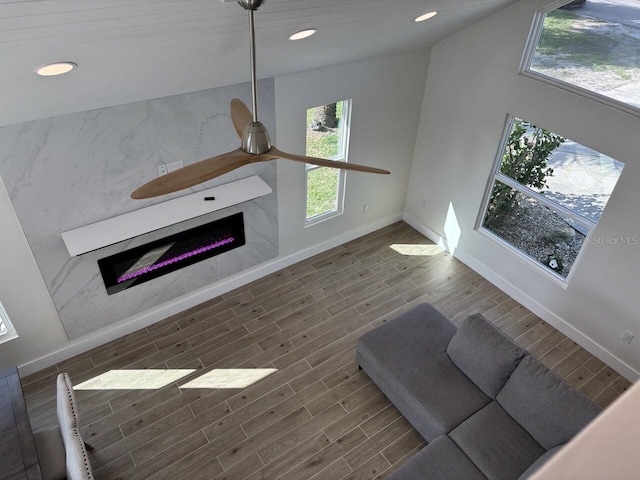 4104 Pine Dale Ct, Hernando Beach, FL 34607 - living area with a premium fireplace, wood finished floors, baseboards, and recessed lighting