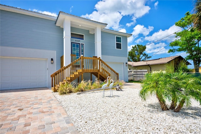 4469 Bahama Dr, Hernando Beach, FL 34607 - view of front of property featuring an attached garage, decorative driveway, and metal roof