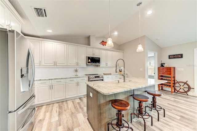 4469 Bahama Dr, Hernando Beach, FL 34607 - kitchen with appliances with stainless steel finishes, a sink, light wood finished floors, lofted ceiling, and white cabinets