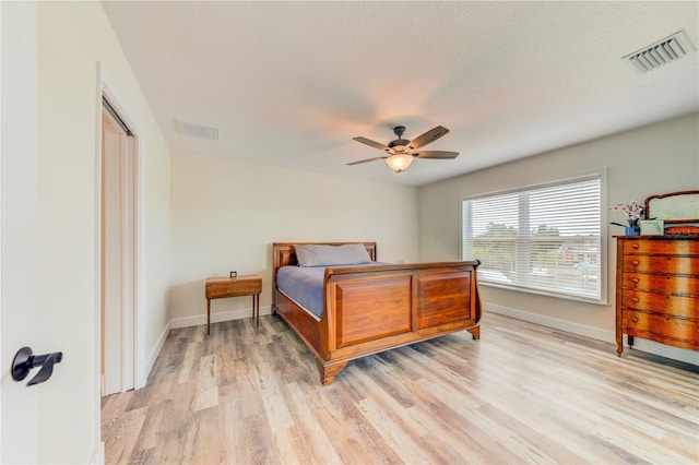 4469 Bahama Dr, Hernando Beach, FL 34607 - bedroom with light wood-style floors, baseboards, and a ceiling fan