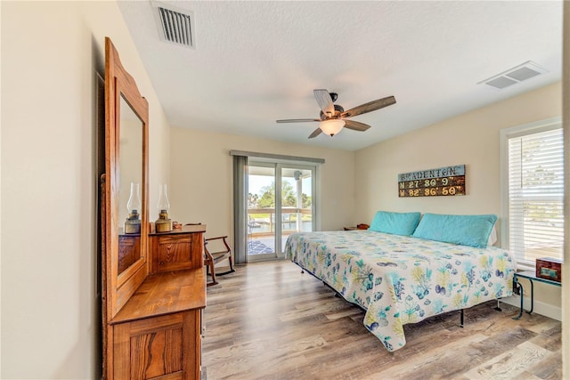 4469 Bahama Dr, Hernando Beach, FL 34607 - bedroom featuring access to exterior, light wood-style floors, ceiling fan, and baseboards