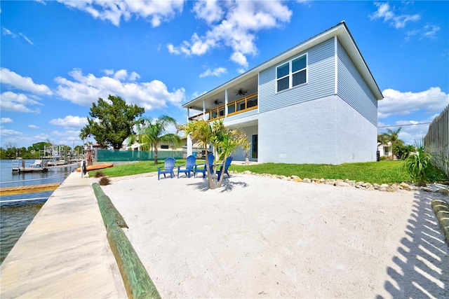 4469 Bahama Dr, Hernando Beach, FL 34607 - rear view of property featuring a ceiling fan, stucco siding, a water view, and a balcony
