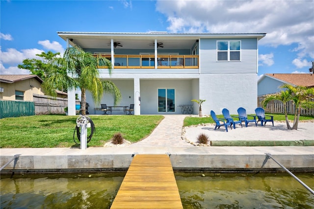 4469 Bahama Dr, Hernando Beach, FL 34607 - back of property featuring a balcony, a patio, ceiling fan, a water view, and stucco siding