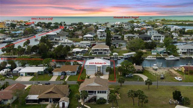 4469 Bahama Dr, Hernando Beach, FL 34607 - aerial view at dusk of a water view, property parcel outlined, and a residential view