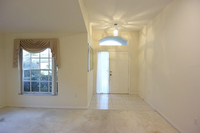 14112 Whitecap Ave, Hudson, FL 34667 - carpeted entrance foyer with tile patterned flooring and baseboards