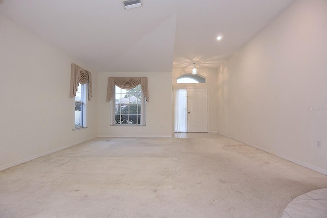 14112 Whitecap Ave, Hudson, FL 34667 - unfurnished living room featuring light colored carpet and baseboards