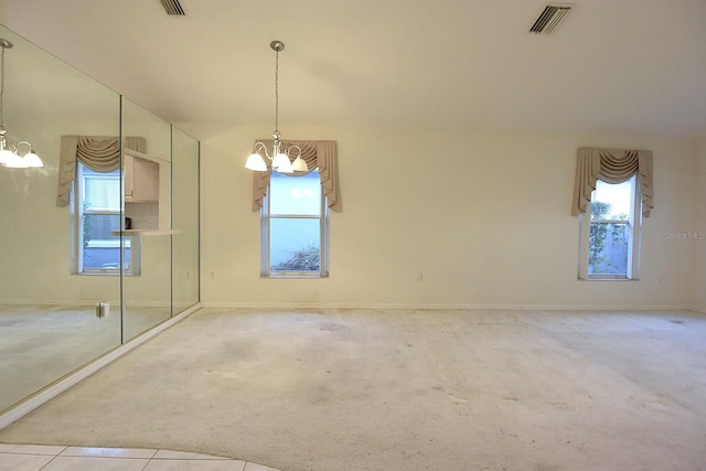 14112 Whitecap Ave, Hudson, FL 34667 - unfurnished dining area with a chandelier, carpet floors, plenty of natural light, and baseboards