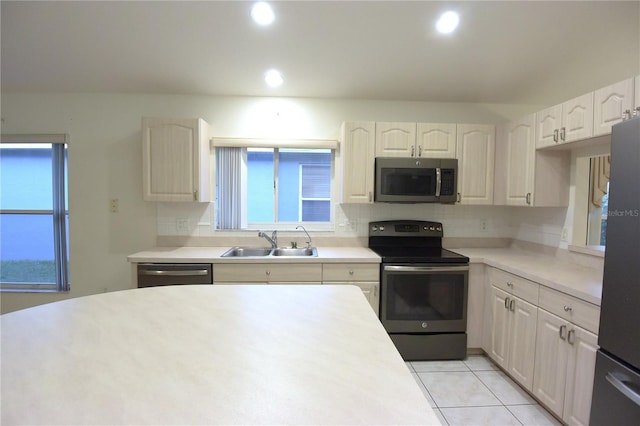 14112 Whitecap Ave, Hudson, FL 34667 - kitchen featuring appliances with stainless steel finishes, a sink, backsplash, plenty of natural light, and recessed lighting