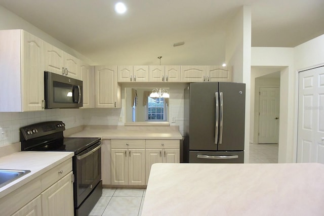 14112 Whitecap Ave, Hudson, FL 34667 - kitchen featuring freestanding refrigerator, electric range, light tile patterned flooring, and light countertops