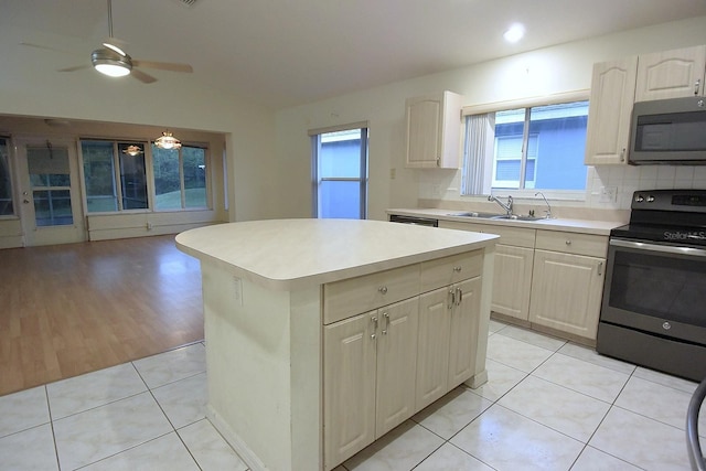 14112 Whitecap Ave, Hudson, FL 34667 - kitchen featuring appliances with stainless steel finishes, a sink, light countertops, a kitchen island, and open floor plan