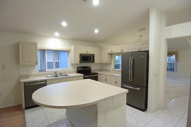 14112 Whitecap Ave, Hudson, FL 34667 - kitchen with stainless steel appliances, a sink, decorative backsplash, light countertops, and a center island