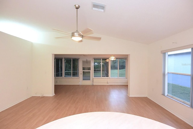 14112 Whitecap Ave, Hudson, FL 34667 - empty room with light wood-style floors, a ceiling fan, vaulted ceiling, and baseboards