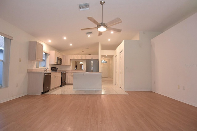 14112 Whitecap Ave, Hudson, FL 34667 - kitchen with appliances with stainless steel finishes, ceiling fan, vaulted ceiling, a kitchen island, and light countertops
