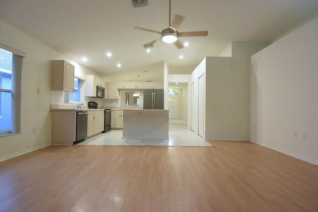 14112 Whitecap Ave, Hudson, FL 34667 - kitchen featuring stainless steel appliances, a ceiling fan, a kitchen island, light wood-style flooring, and vaulted ceiling