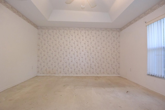 14112 Whitecap Ave, Hudson, FL 34667 - spare room with a tray ceiling, ceiling fan, and baseboards