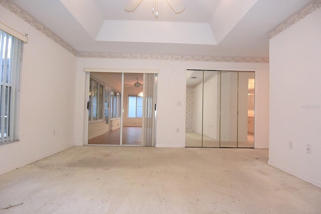 14112 Whitecap Ave, Hudson, FL 34667 - unfurnished bedroom with a tray ceiling and multiple windows