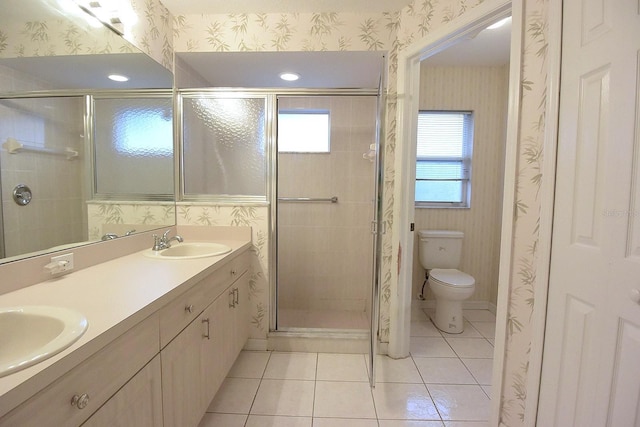 14112 Whitecap Ave, Hudson, FL 34667 - bathroom with tile patterned flooring, toilet, a stall shower, double vanity, and wallpapered walls