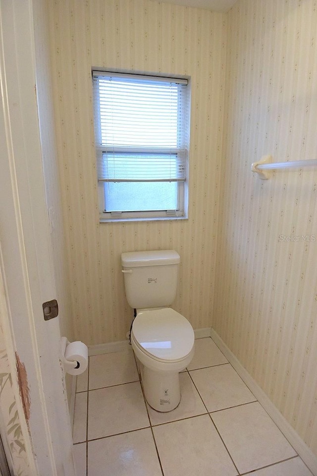 14112 Whitecap Ave, Hudson, FL 34667 - bathroom with healthy amount of natural light, toilet, and baseboards