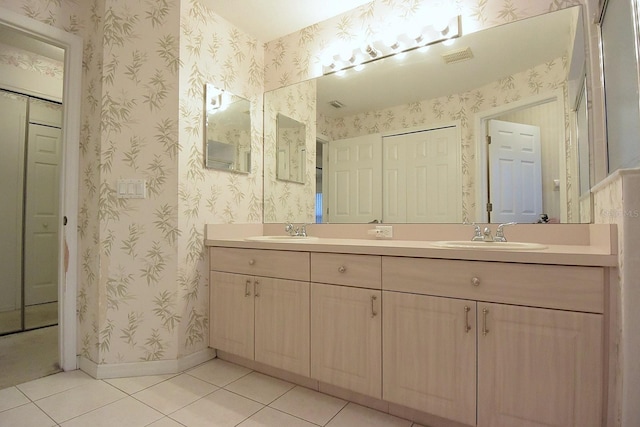 14112 Whitecap Ave, Hudson, FL 34667 - full bathroom featuring double vanity, tile patterned floors, wallpapered walls, a closet, and baseboards