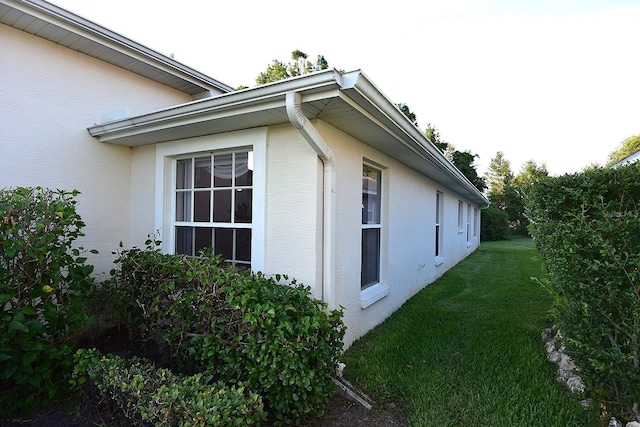 14112 Whitecap Ave, Hudson, FL 34667 - view of home's exterior with stucco siding and a yard