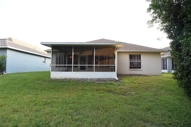14112 Whitecap Ave, Hudson, FL 34667 - rear view of house with a yard, a sunroom, and stucco siding
